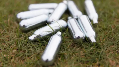 Nitrous oxide canisters used as whippets highlighting dangers of inhalant abuse and teen substance misuse