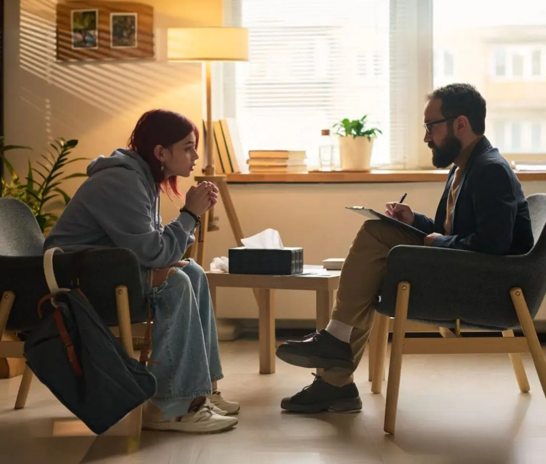 Therapist guiding teen through holistic counseling for emotional healing Therapist guiding teen through holistic counseling for emotional healing