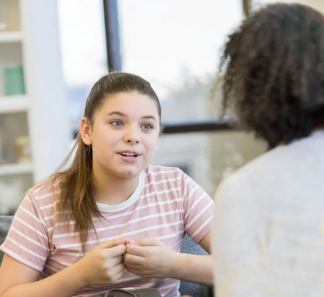 A teen and therapist having a one-on-one session about trauma-informed care A teen and therapist having a one-on-one session about trauma-informed care