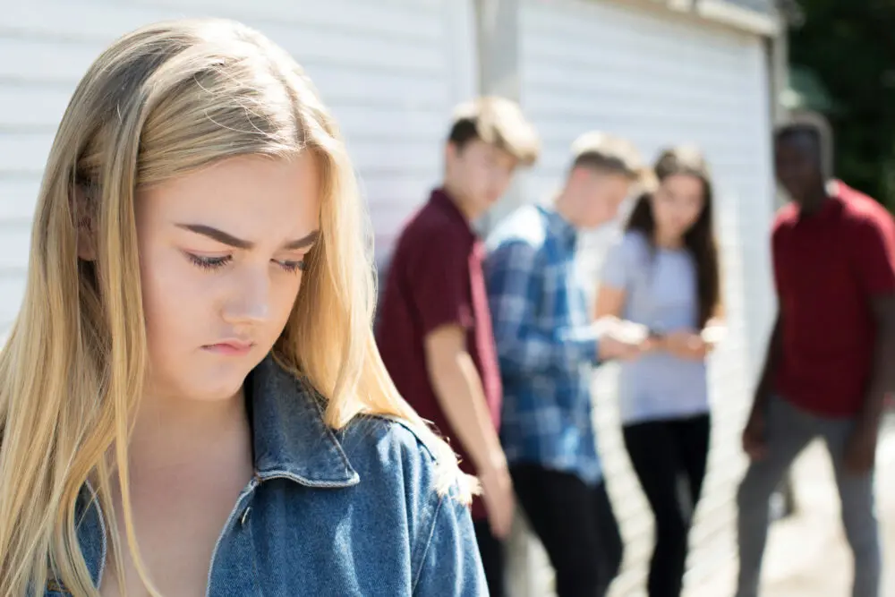 peer-pressure-and-teen-addiction teens gossip about a girl facing peer pressure and addiction