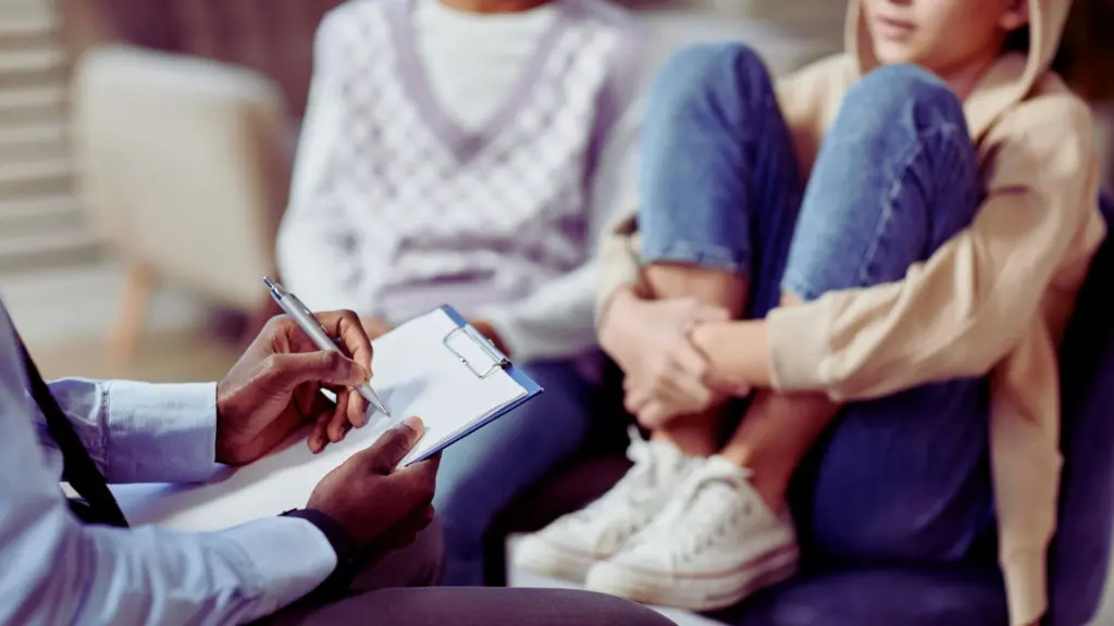 Teen sitting with parents during a counseling session.